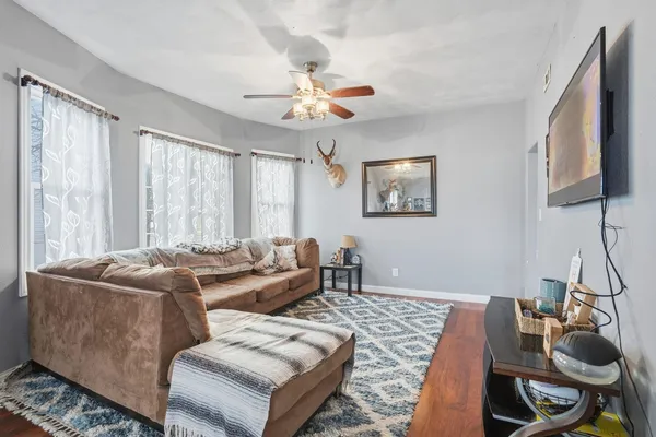 a living room with furniture and a chandelier