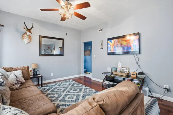 a living room with furniture and a flat screen tv