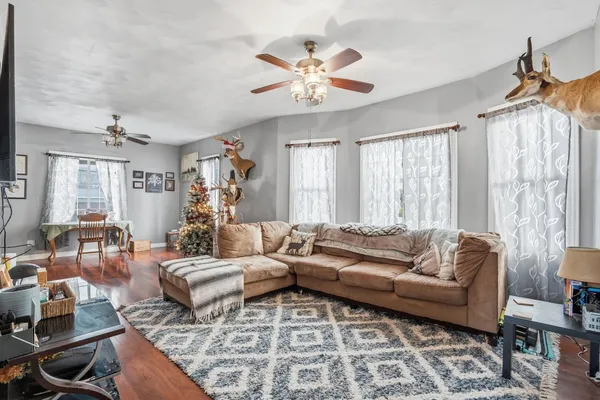 a living room with furniture and a chandelier