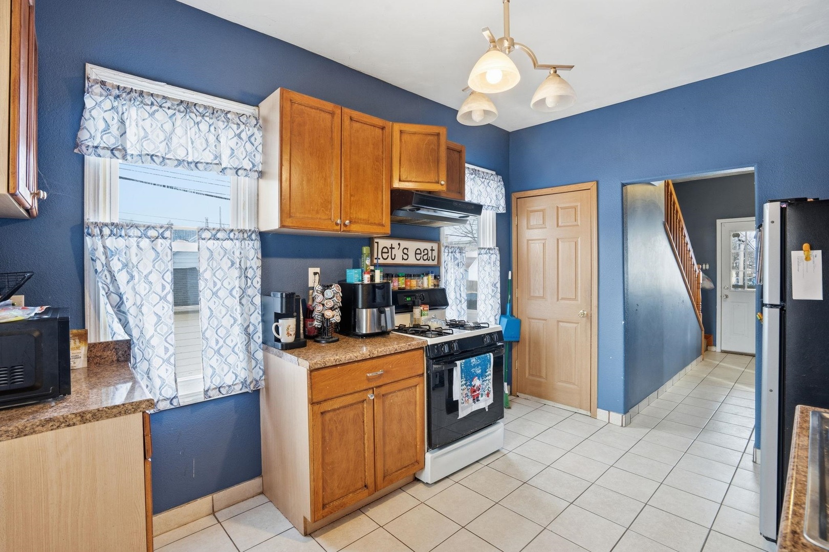 314 Washington Street Davenport, IA 52802 - Photo 9 of 22 a kitchen with stainless steel appliances granite countertop a refrigerator a stove and a sink