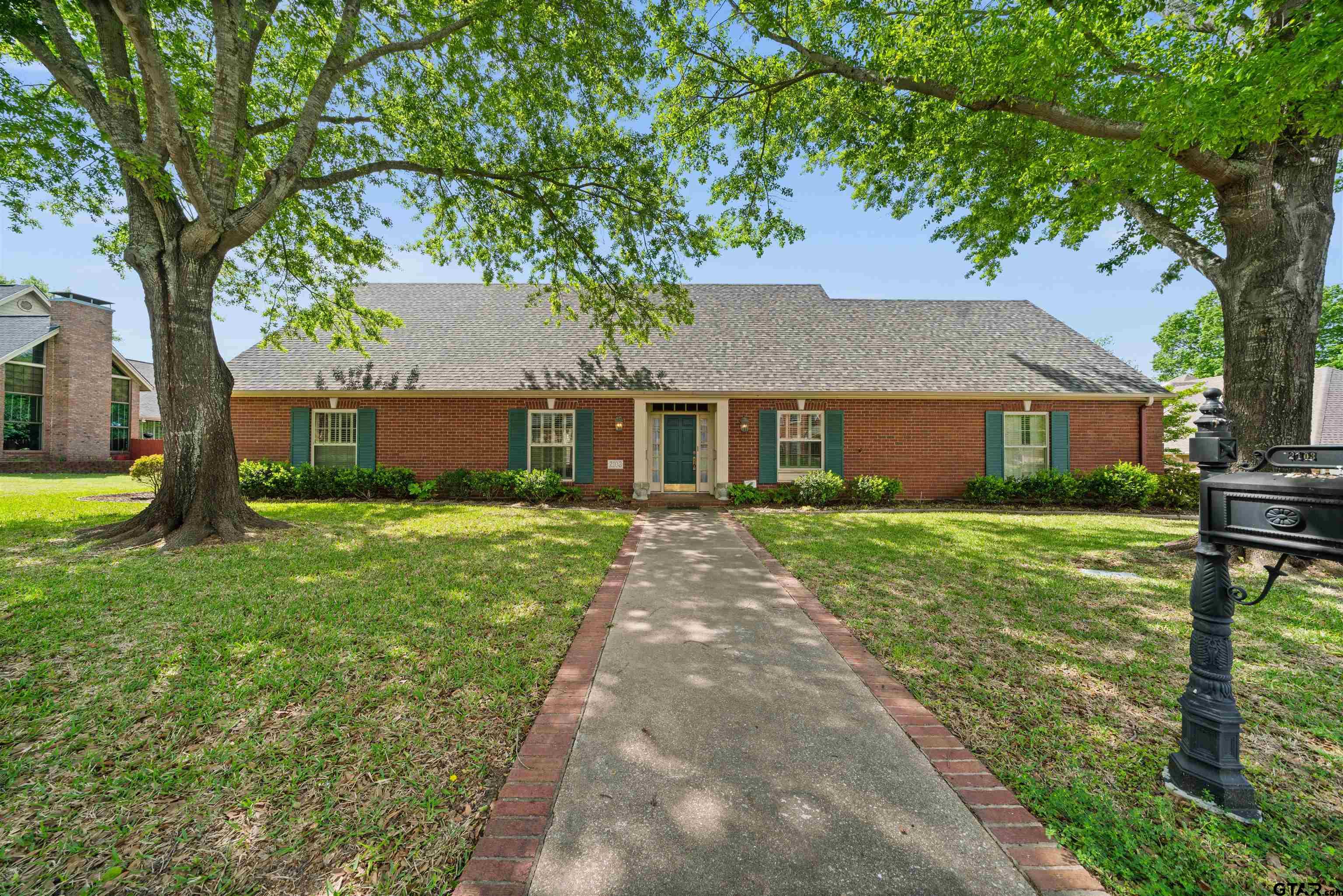 2103 Baylor Street Jacksonville, TX 75766 - Photo 1 of 45 a front view of a house with a garden