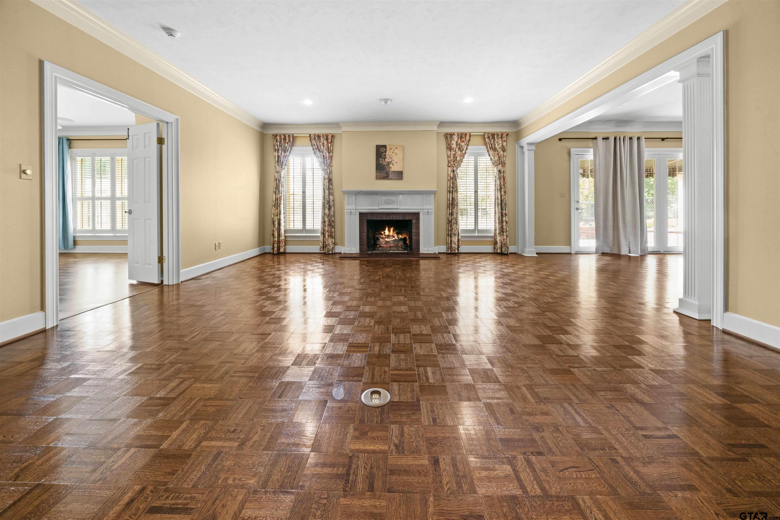 2103 Baylor Street Jacksonville, TX 75766 - Photo 15 of 45 a view of empty room with wooden floor and fireplace