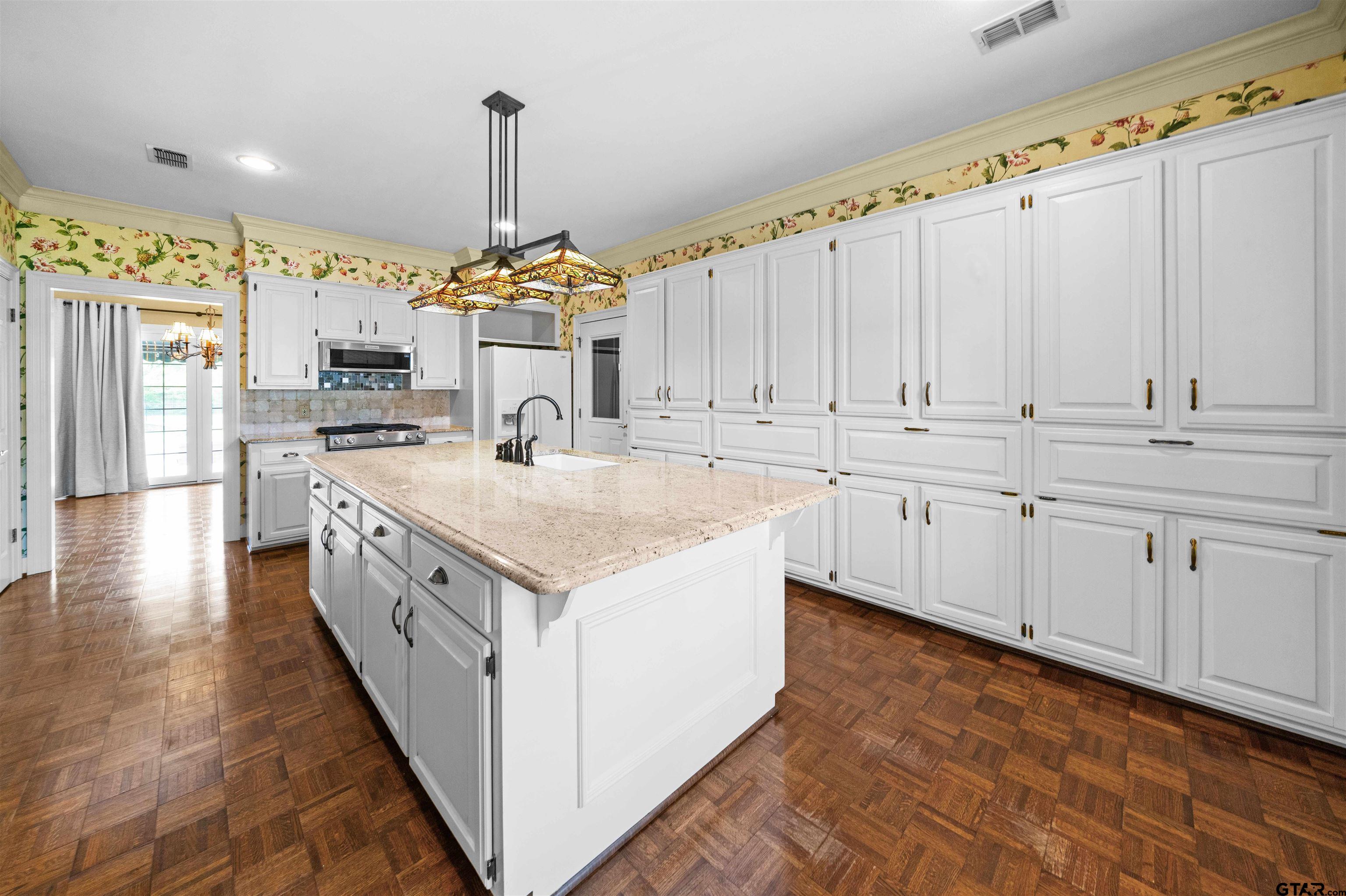 2103 Baylor Street Jacksonville, TX 75766 - Photo 23 of 45 a kitchen with a sink stove and cabinets