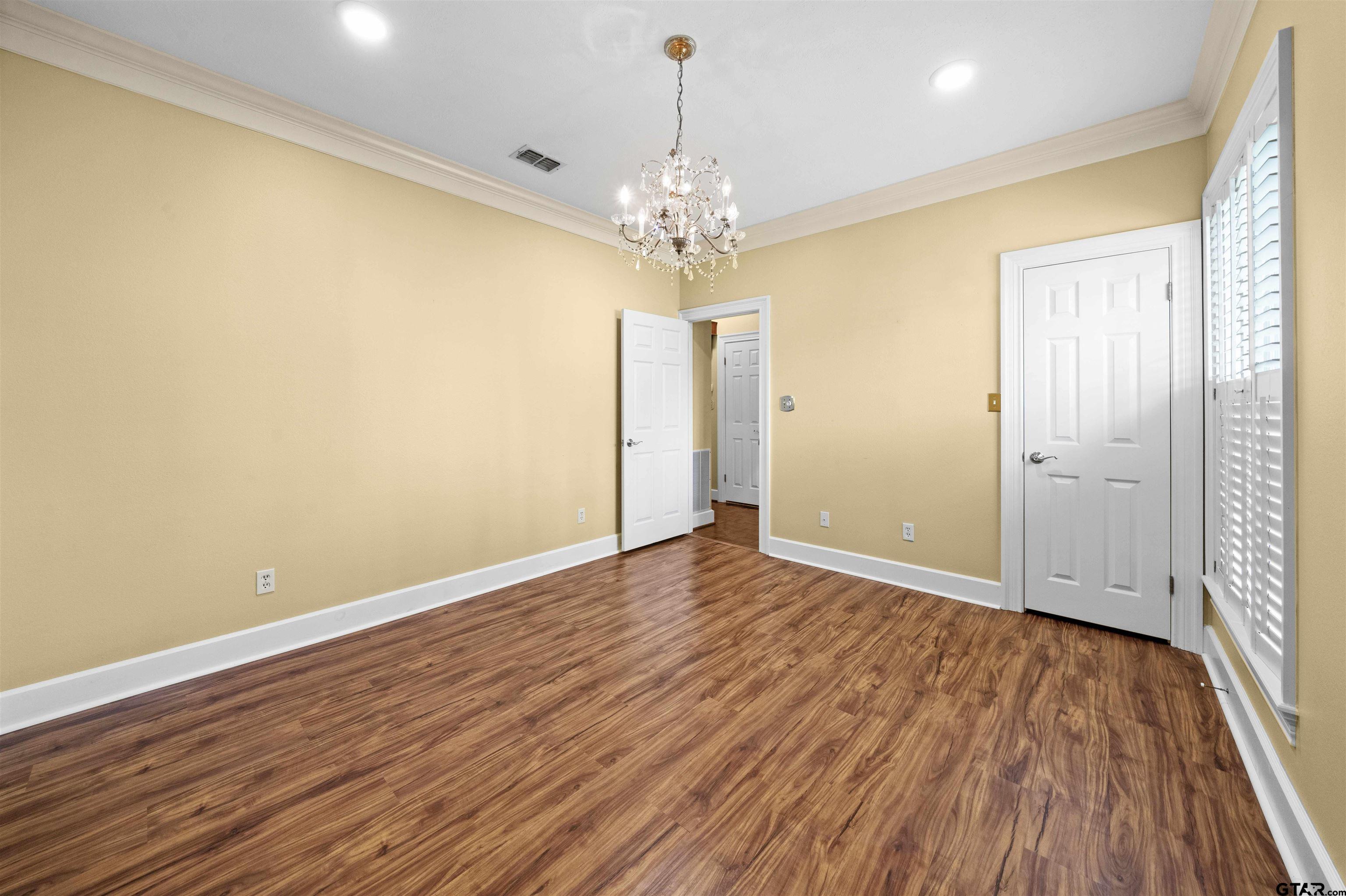 2103 Baylor Street Jacksonville, TX 75766 - Photo 36 of 45 wooden floor in an empty room with a window