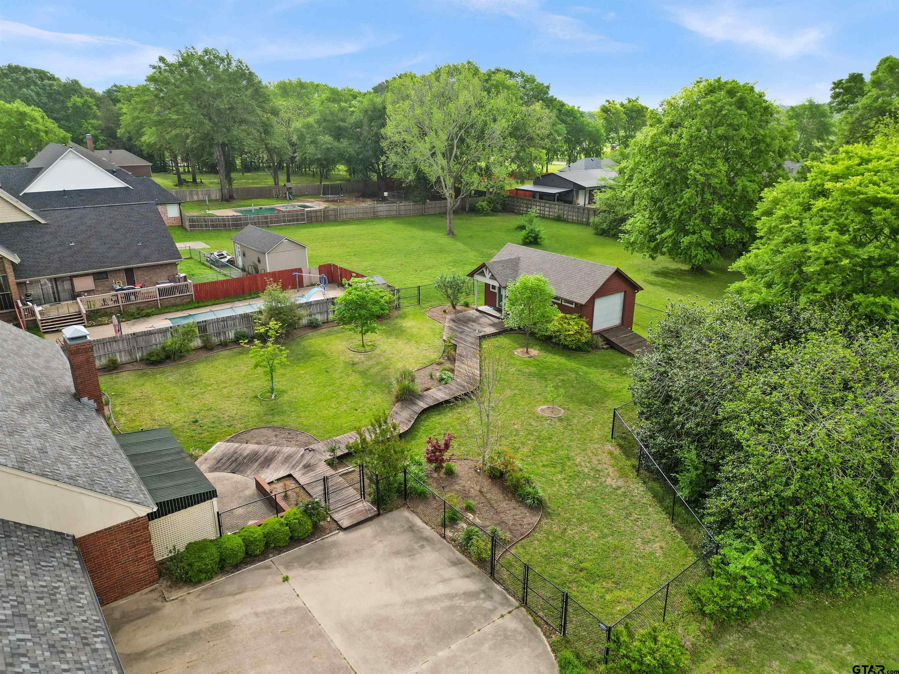 2103 Baylor Street Jacksonville, TX 75766 - Photo 10 of 45 an aerial view of a house with swimming pool a patio and yard