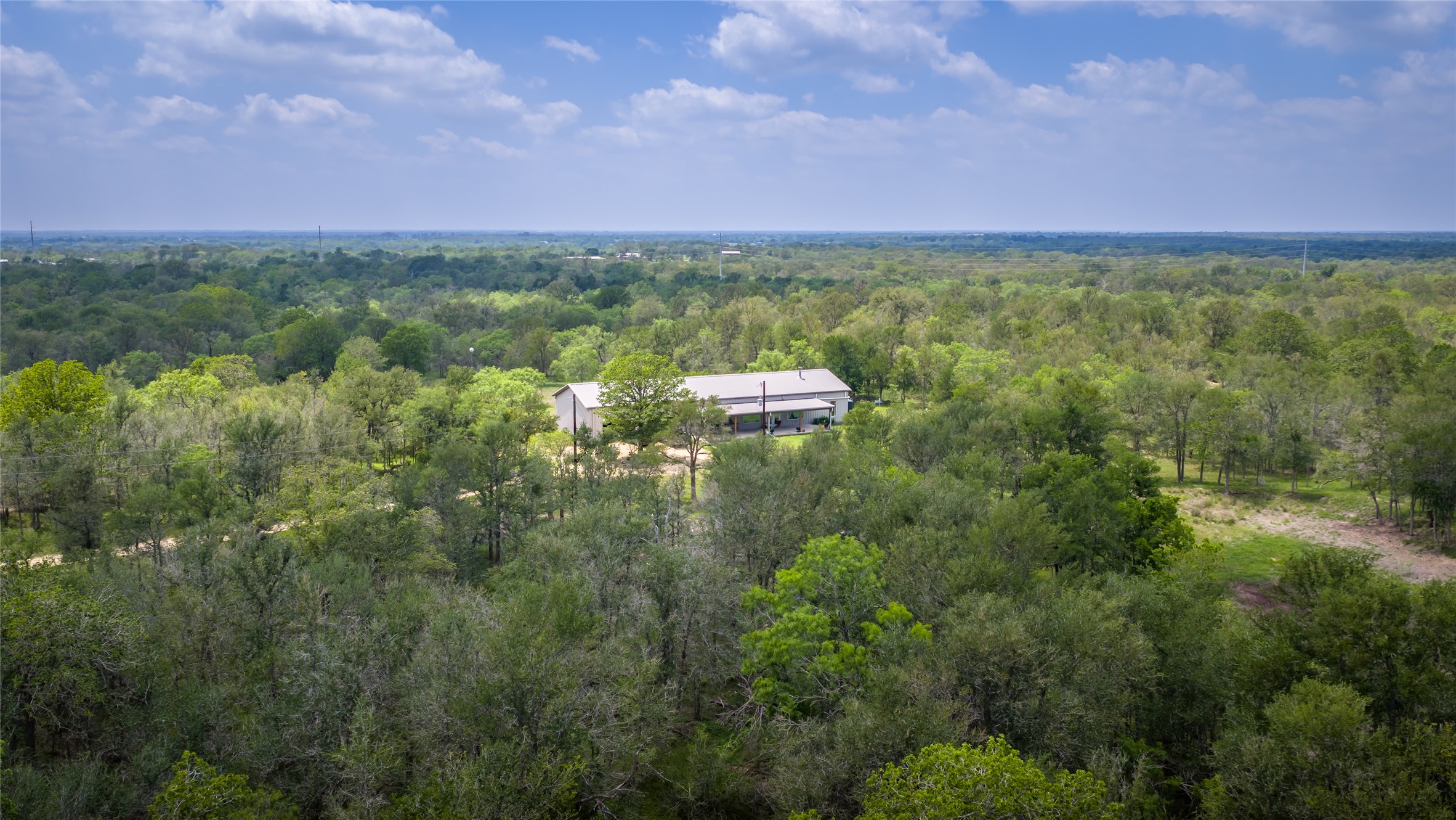 4082 Old Colony Line Road Lockhart, TX 78644 - Photo 32 of 40 A private home is nestled within a verdant forest, offering serene, undisturbed living.