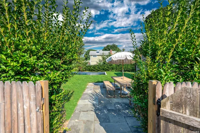 a view of a yard with potted plants