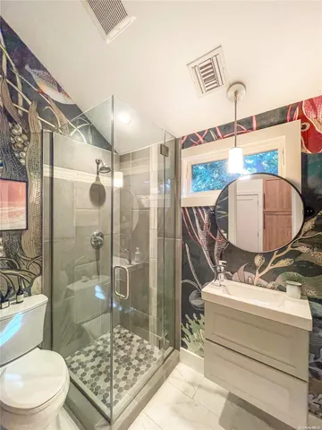 a bathroom with a sink toilet and shower