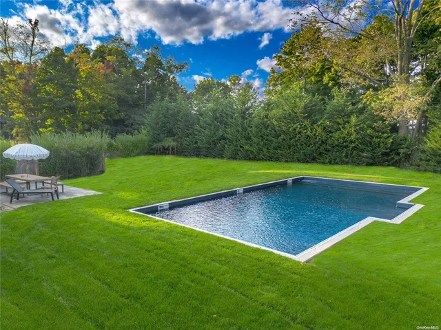 a view of a backyard with swimming pool