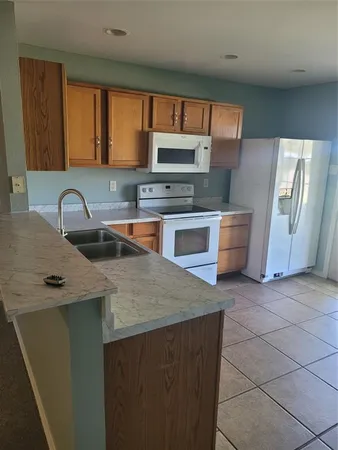a kitchen with stainless steel appliances a sink stove and cabinets