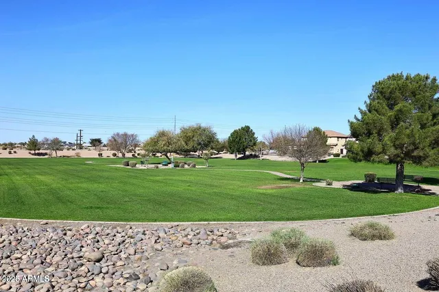 a yard with lots of green space and trees