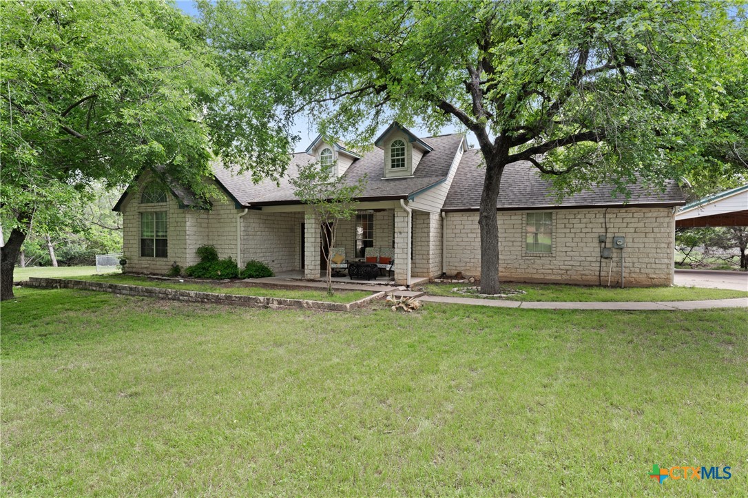 a view of a house with pool and a yard