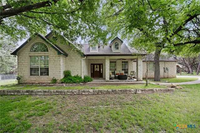 a front view of a house with a garden and porch