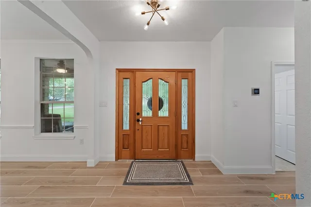 a view of a door and wooden floor in a room