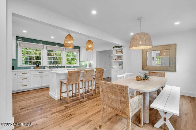 a kitchen with stainless steel appliances a stove a sink a oven and a large window