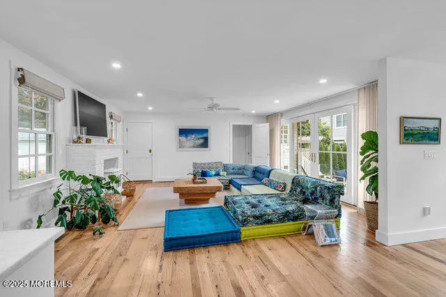 a living room with furniture a fireplace and a flat screen tv