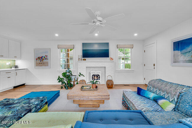 1204 5th Avenue Spring Lake, NJ 07762 - Photo 17 of 36 a living room with furniture a fireplace and a flat screen tv