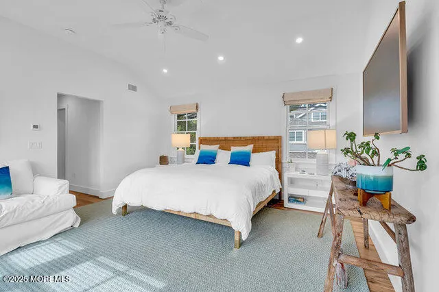 a white bath tub sitting next to a white wall
