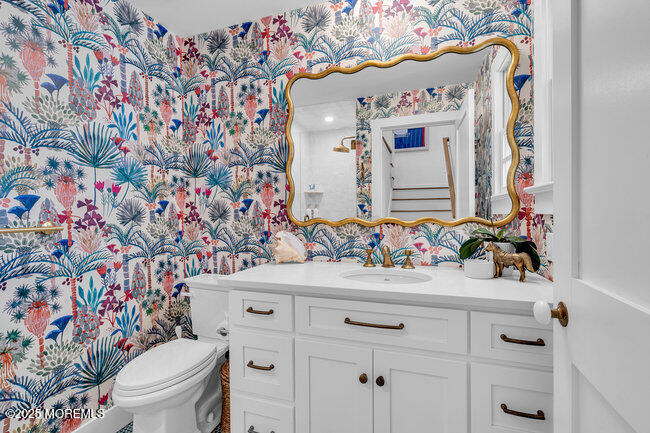 1204 5th Avenue Spring Lake, NJ 07762 - Photo 24 of 36 a bathroom with a sink mirror vanity and toilet