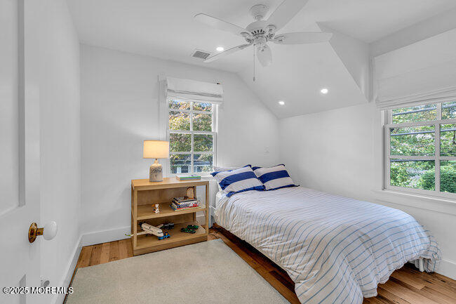 1204 5th Avenue Spring Lake, NJ 07762 - Photo 29 of 36 a bedroom with a bed a chandelier and a window