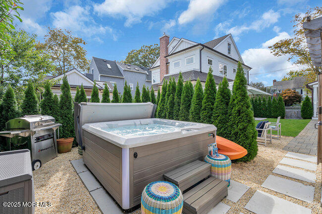 1204 5th Avenue Spring Lake, NJ 07762 - Photo 35 of 36 a view of a patio with a table and chairs under an umbrella