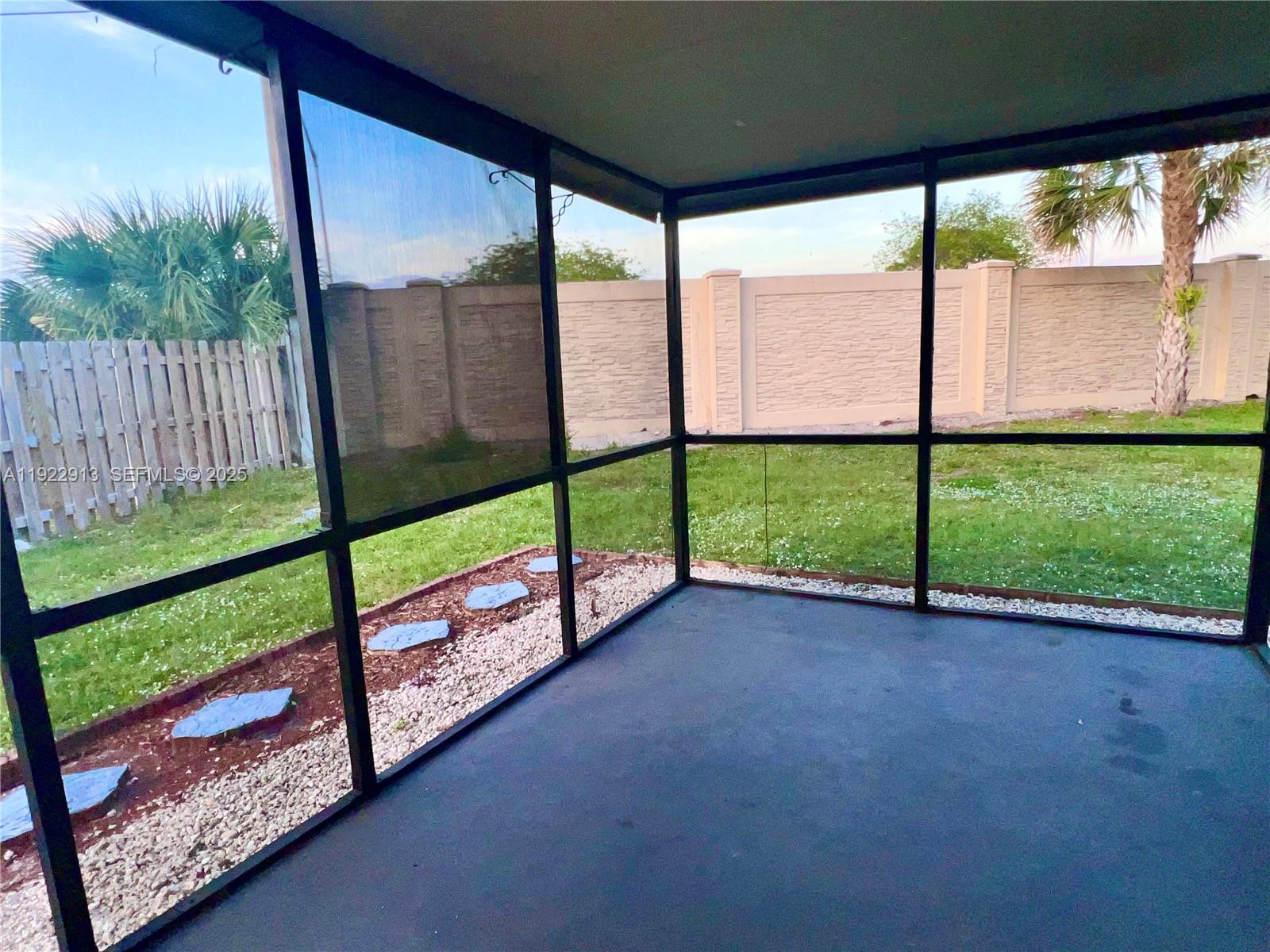 1701 Southwest 83rd Terrace Miramar, FL 33025 - Photo 14 of 18 a view of a yard with porch and wooden fence