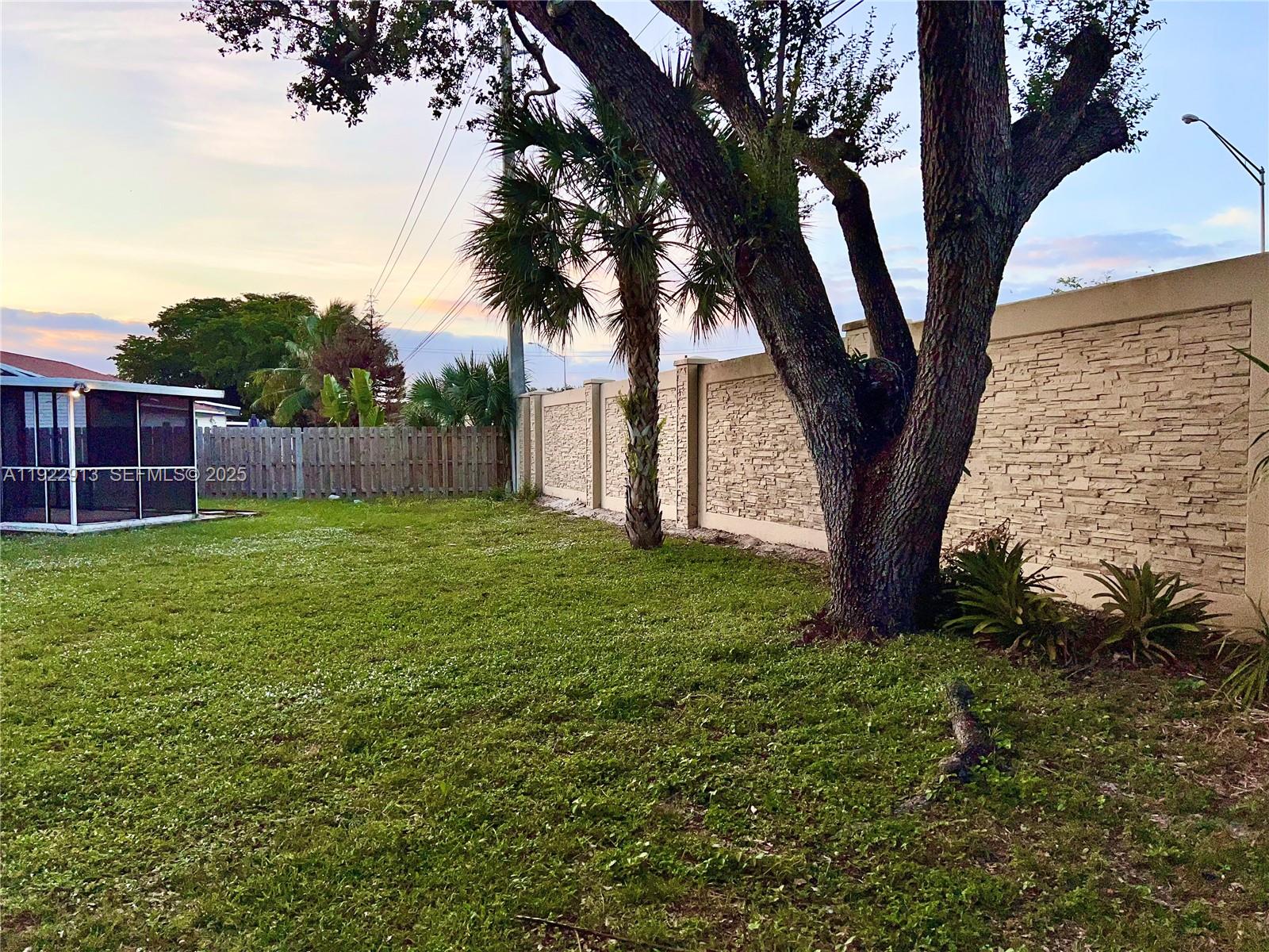 1701 Southwest 83rd Terrace Miramar, FL 33025 - Photo 16 of 18 a view of backyard with a barn and a large tree