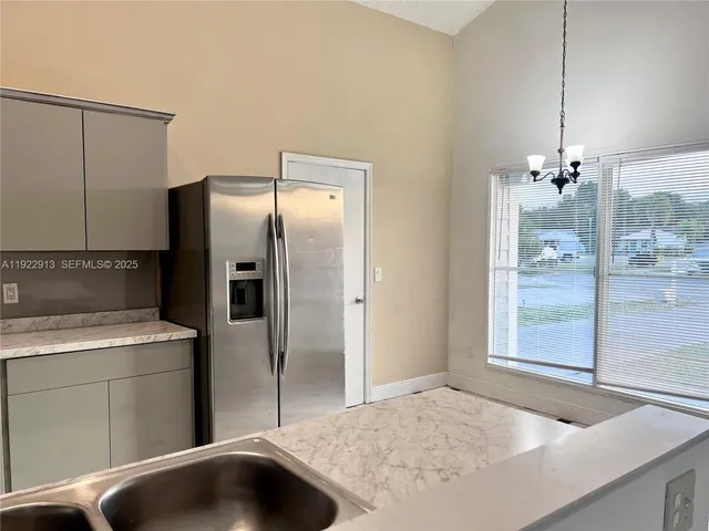 a kitchen with a sink and refrigerator