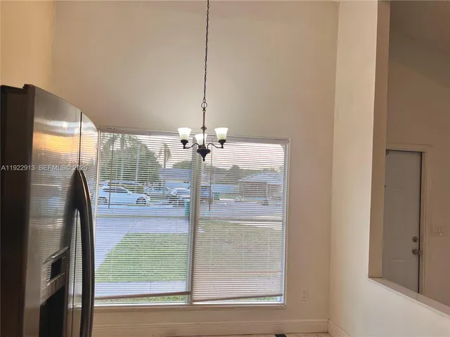 a view of a room with a floor to ceiling window and an outdoor space