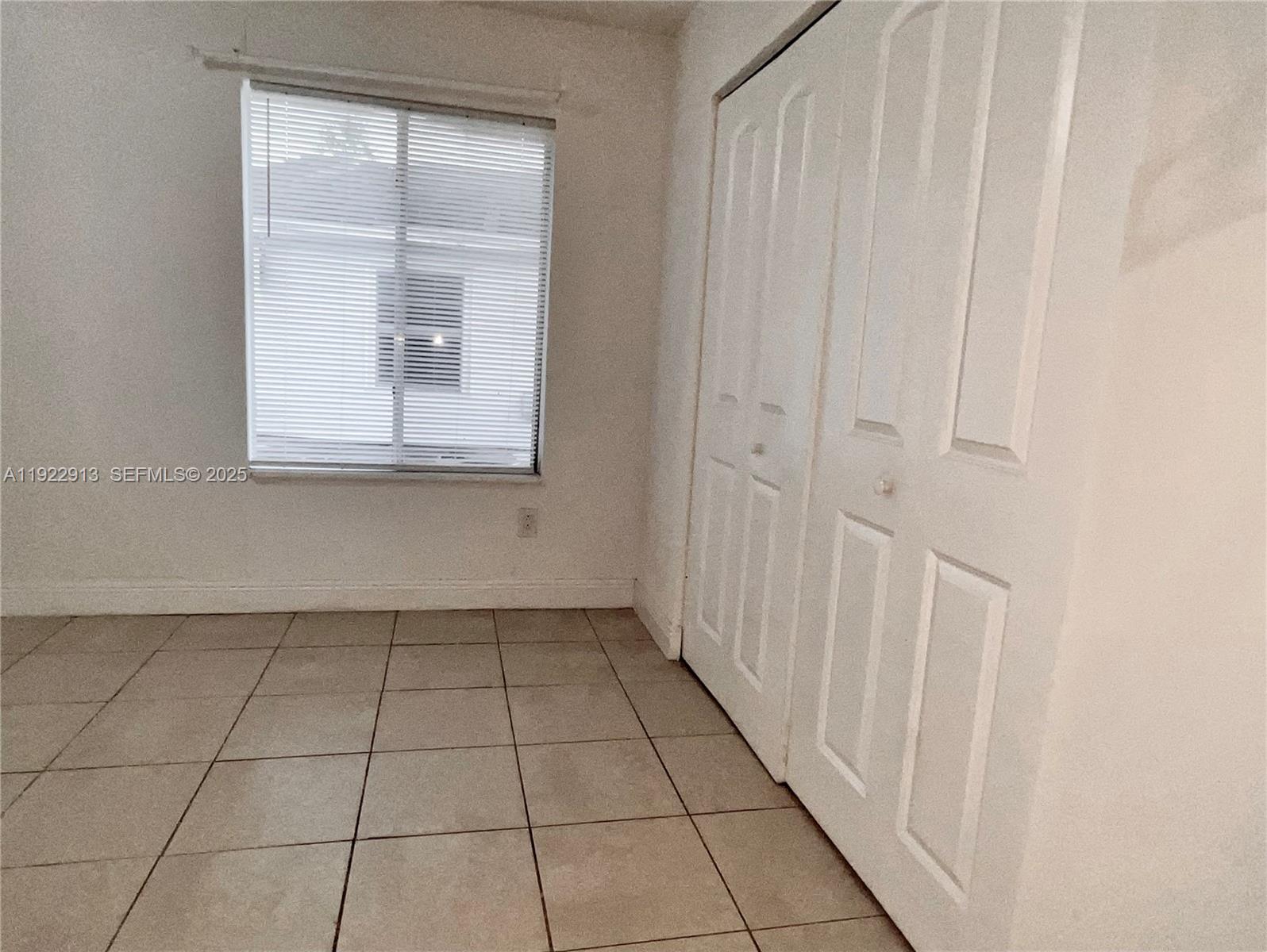 1701 Southwest 83rd Terrace Miramar, FL 33025 - Photo 8 of 18 a view of an empty room with a window