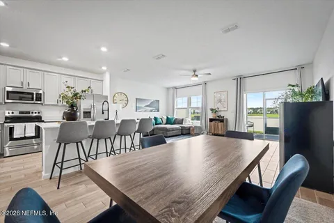a view of a dining room with furniture and wooden floor