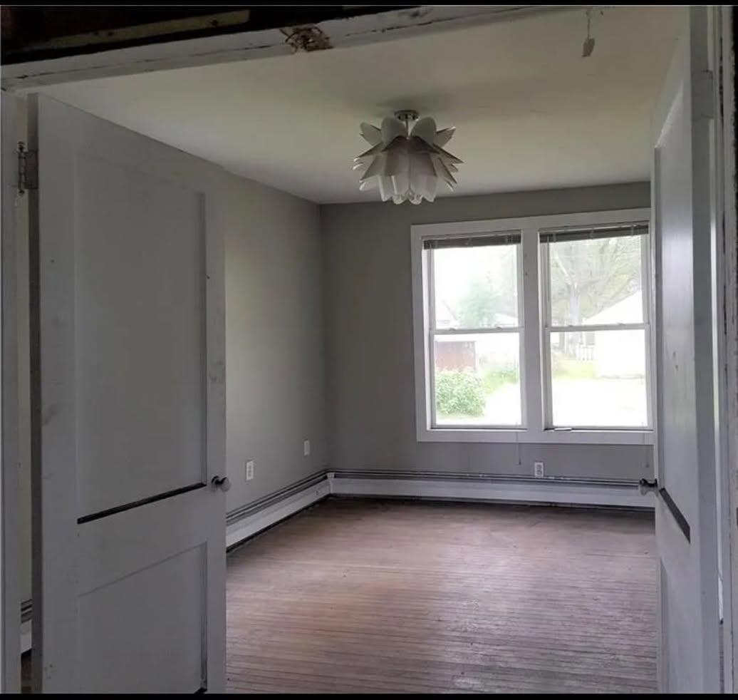 113 Cunningham Avenue Danville, IL 61832 - Photo 19 of 25 an empty room with a window and a ceiling fan