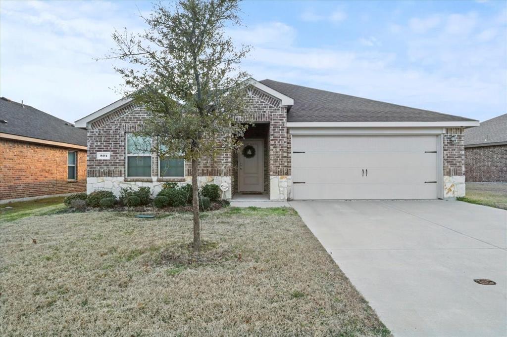 Ranch-style house with a garage and a front yard