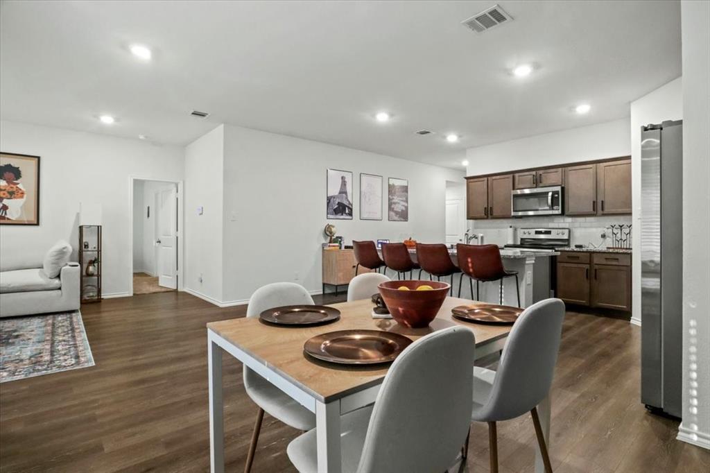804 Roland Drive Fate, TX 75189 - Photo 14 of 27 a living room with stainless steel appliances furniture and a view of kitchen