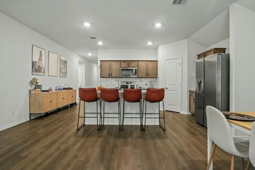 804 Roland Drive Fate, TX 75189 - Photo 15 of 27 a living room with furniture and a wooden floor