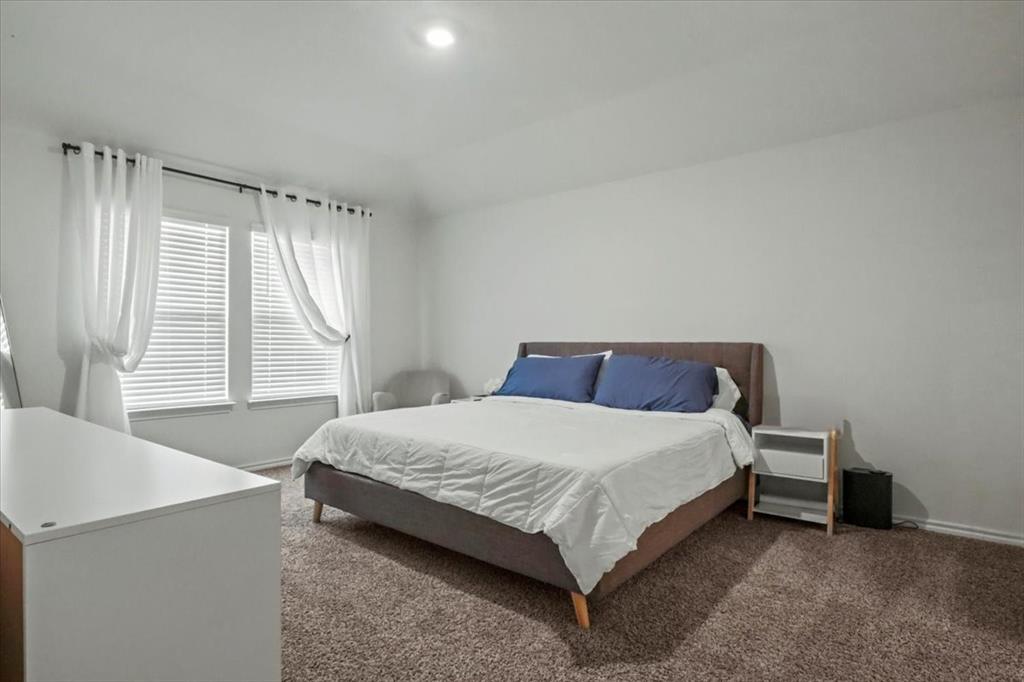 804 Roland Drive Fate, TX 75189 - Photo 22 of 27 a bedroom with a bed and a window