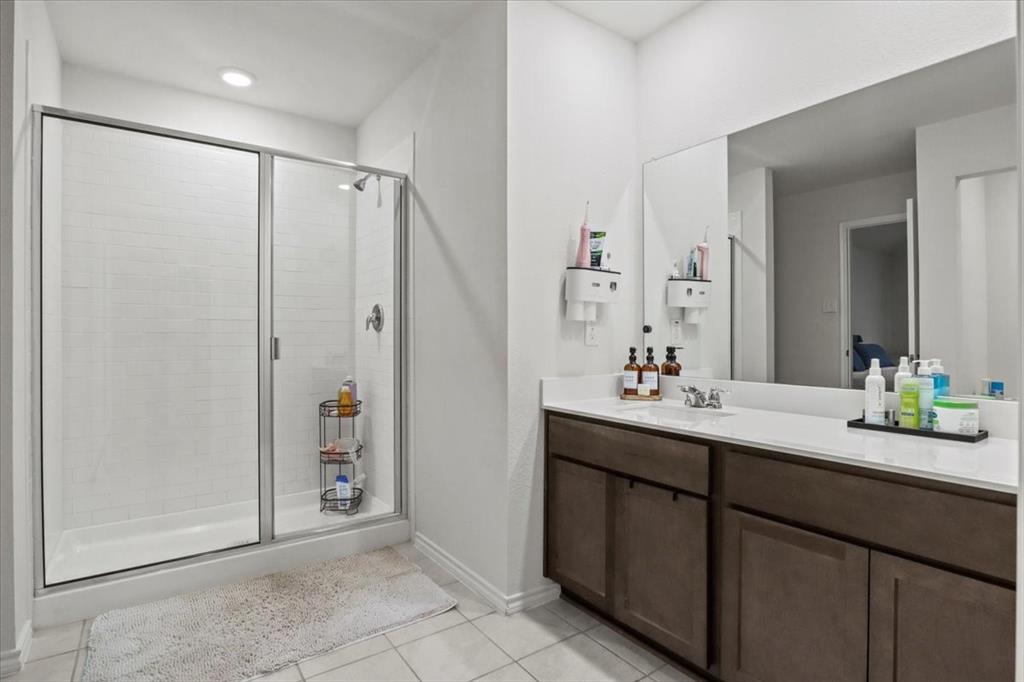 804 Roland Drive Fate, TX 75189 - Photo 25 of 27 a bathroom with a double vanity sink mirror and shower