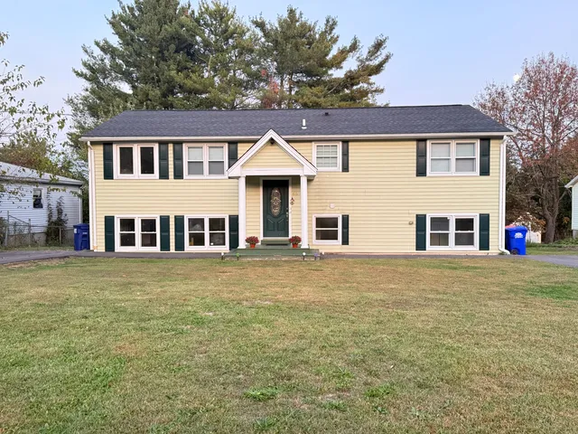 a front view of a house with a garden