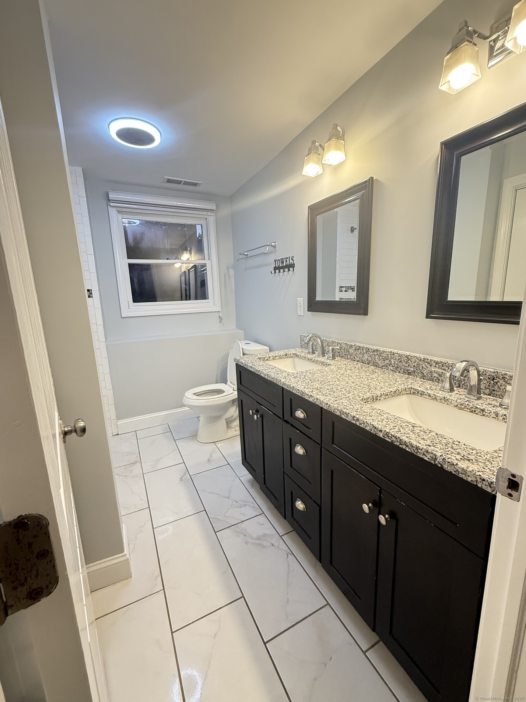 65 Muir Terrace, Unit 1 Southington, CT 06489 - Photo 14 of 24 a spacious bathroom with a granite countertop sink mirror and bathtub