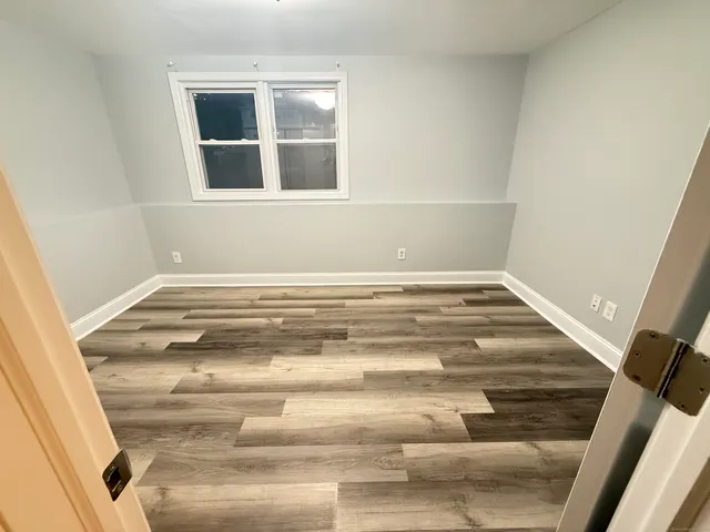 a view of a room with wooden floor and staircase
