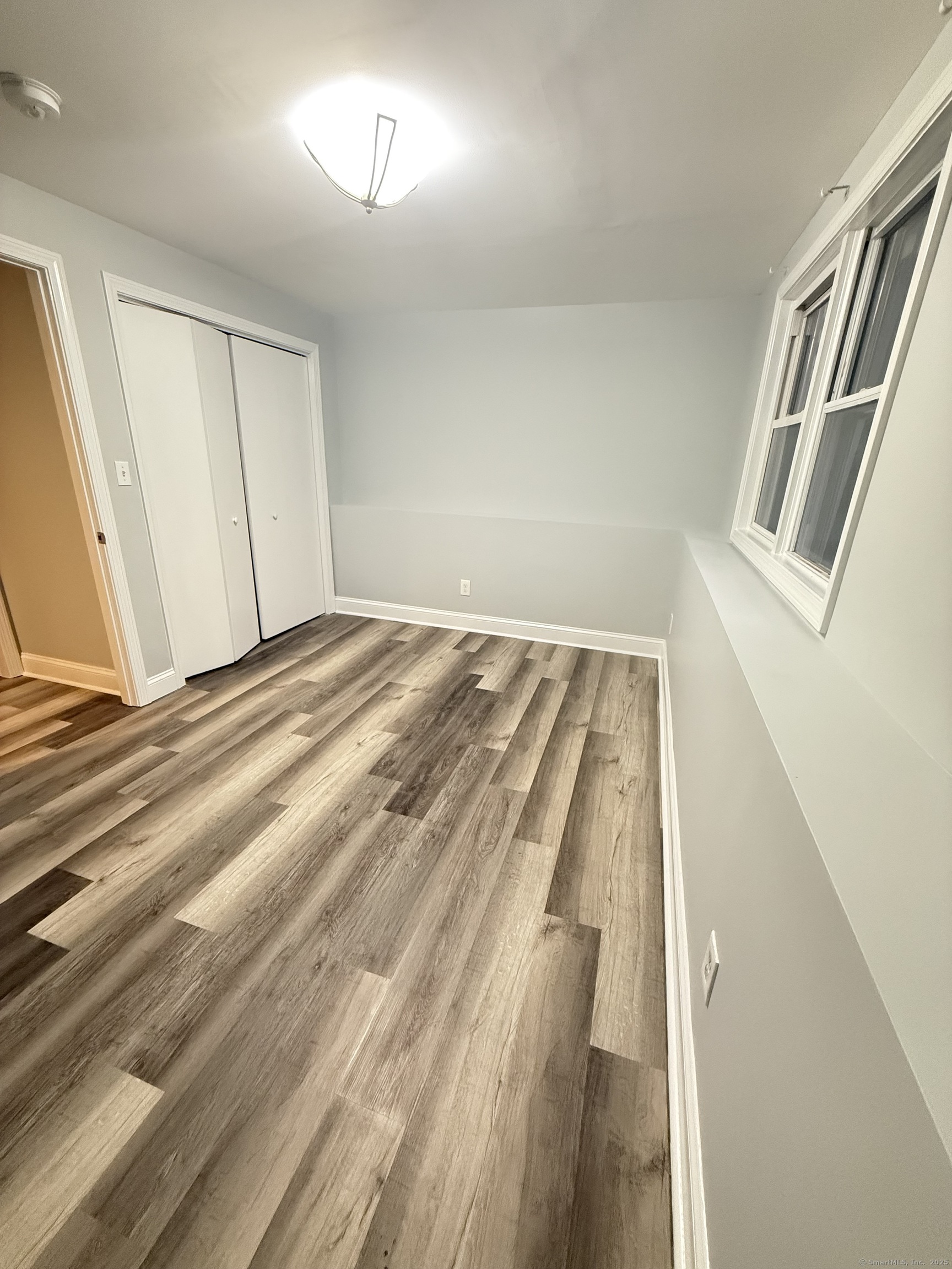 65 Muir Terrace, Unit 1 Southington, CT 06489 - Photo 24 of 24 a view of a room with wooden floor and staircase