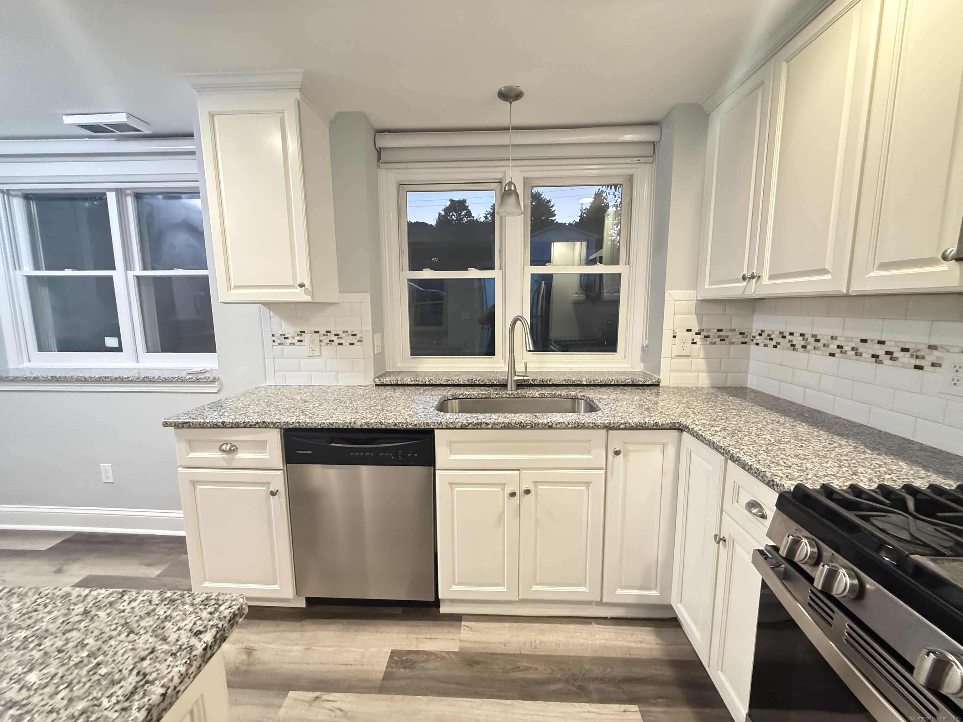65 Muir Terrace, Unit 1 Southington, CT 06489 - Photo 10 of 24 a kitchen with stainless steel appliances granite countertop a stove and cabinets