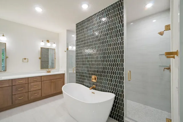 a bathroom with a bathtub a sink a toilet and shower