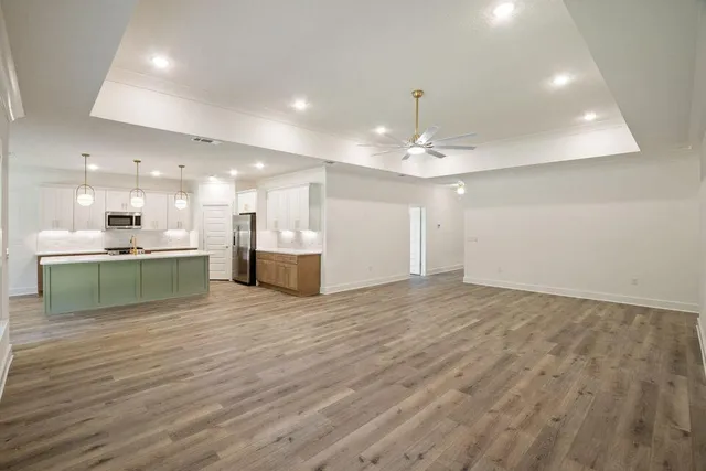 a view of kitchen with kitchen island and stainless steel appliances