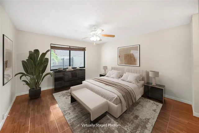 a bedroom with a bed furniture potted plant and a window