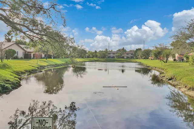a view of a lake with houses in the back