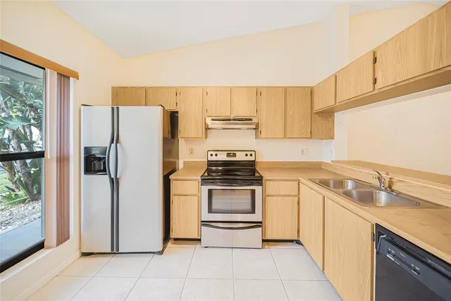 a kitchen with a refrigerator sink and stove