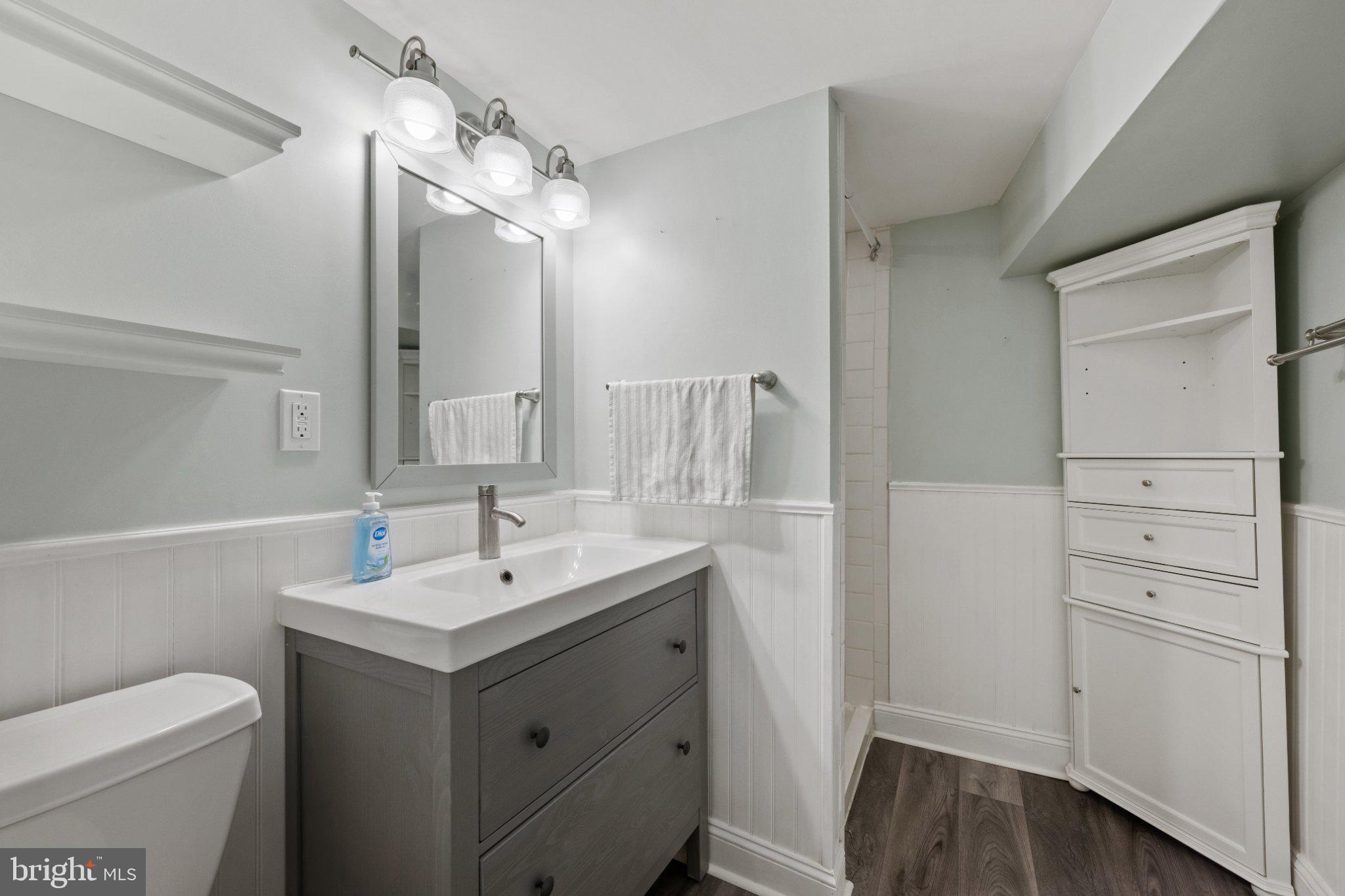 615 South Clinton Street Baltimore, MD 21224 - Photo 15 of 39 a bathroom with a sink a toilet and a mirror