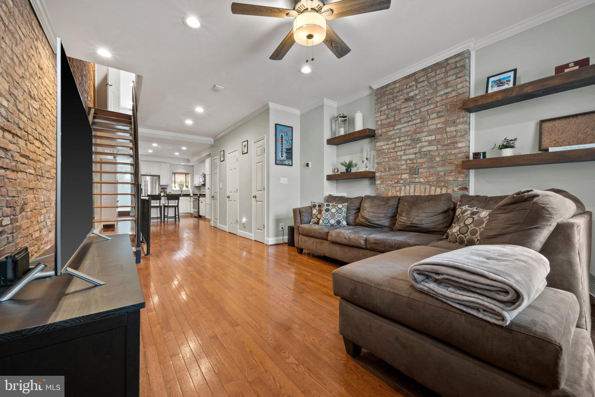 615 South Clinton Street Baltimore, MD 21224 - Photo 2 of 39 a living room with furniture and kitchen view