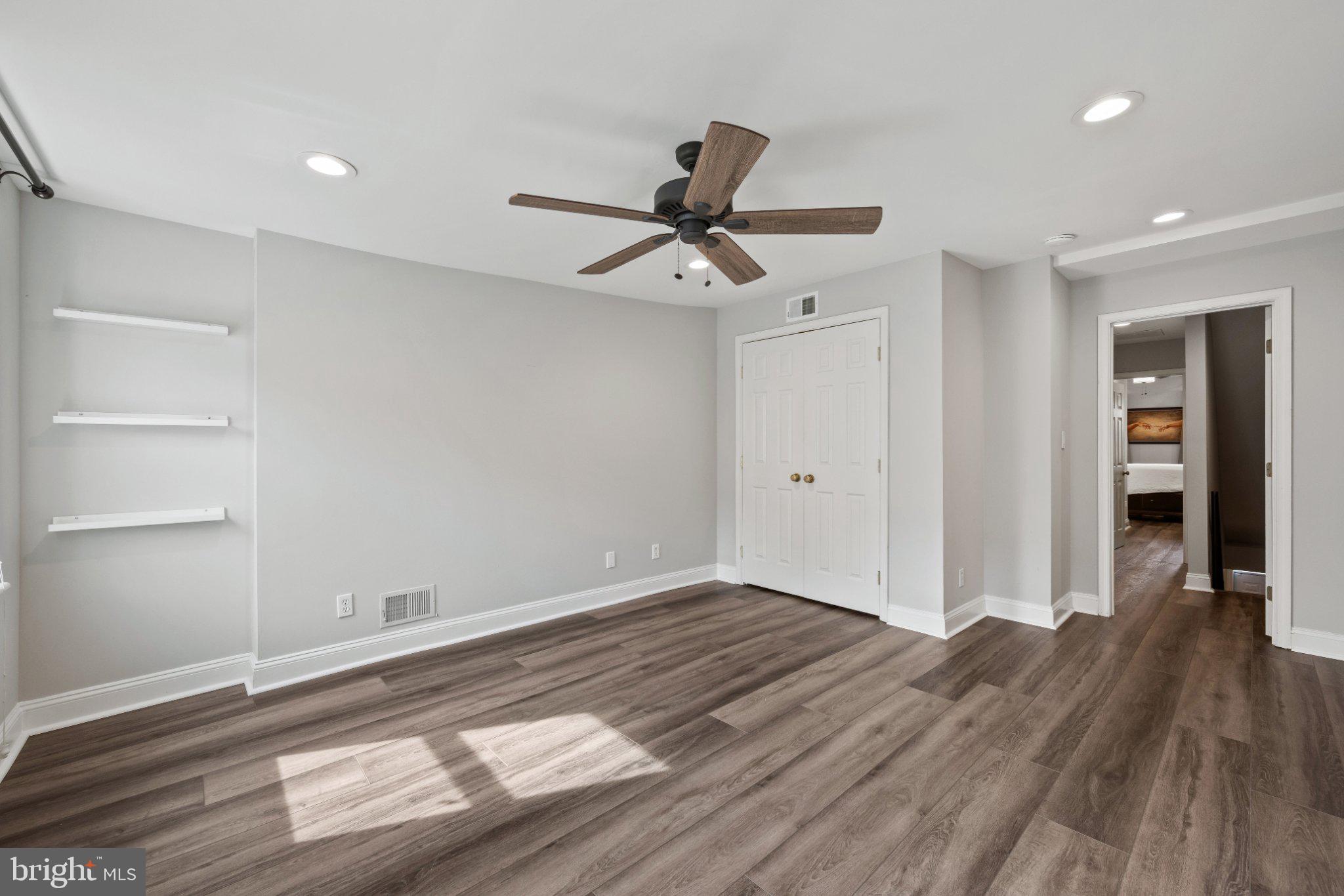 615 South Clinton Street Baltimore, MD 21224 - Photo 21 of 39 a view of a room with wooden floor and a ceiling fan
